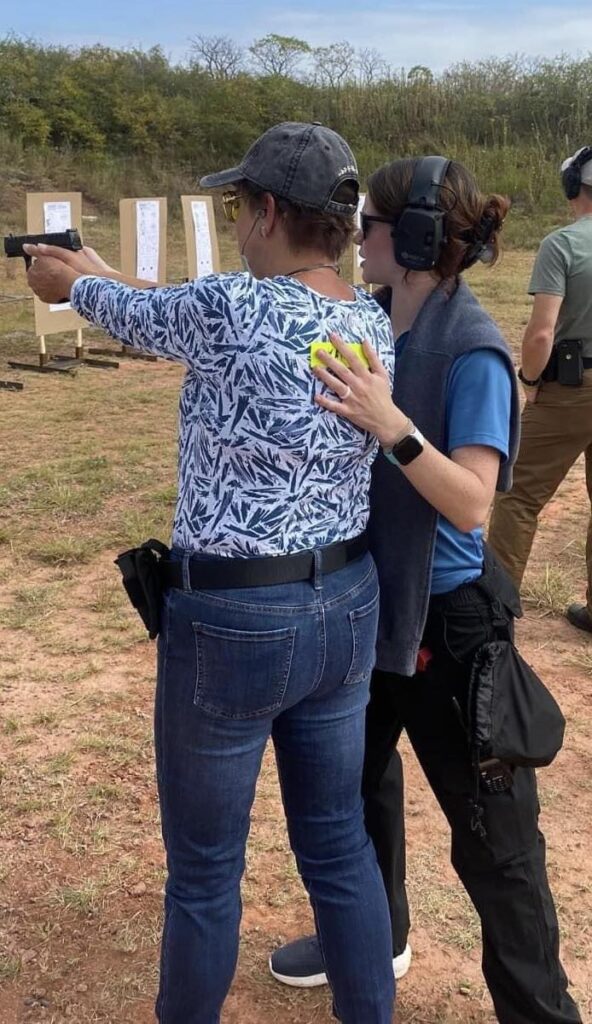 Natalee Weidner, Head of instruction and co-Owner of Warrior Monk Academy Teaching at the Oklahoma City Guardian Conference in 2023 deliberately coaching a firearms student